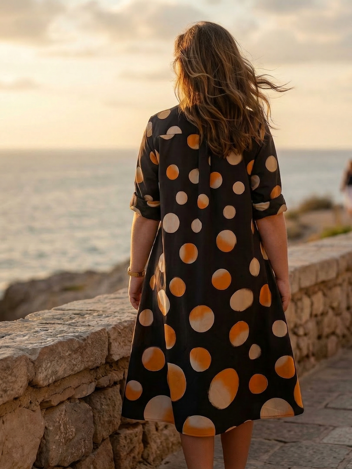Knee-length polka-dot dress with collared neckline and side pockets for women