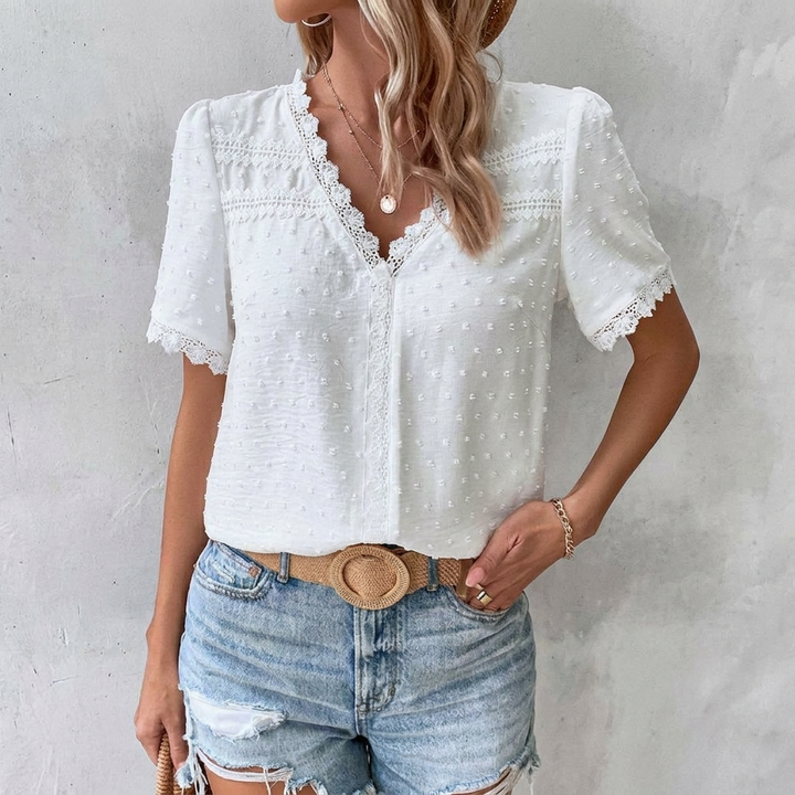Bohemian-inspired blouse with a V-neck, Swiss dots, and lace trim for women